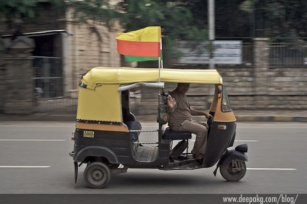 Pan shot of an auto with the flag of Karnataka