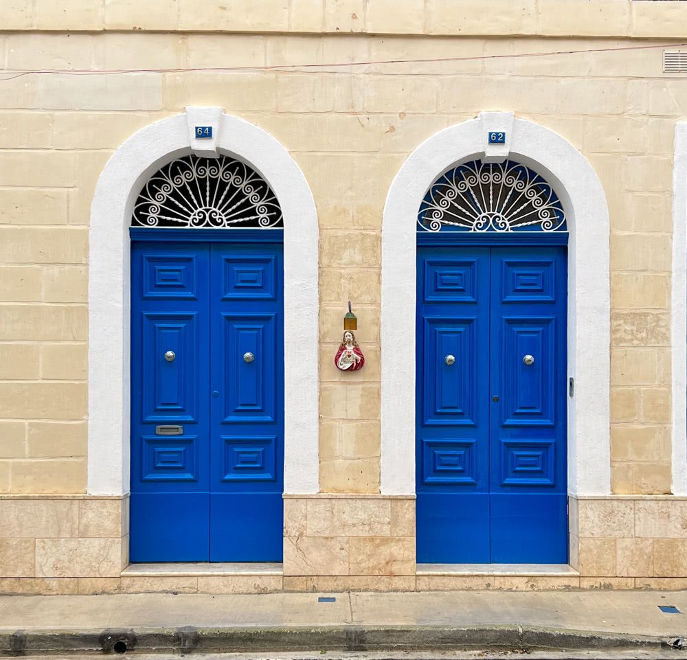 Blue doors with a figurine of Jesus