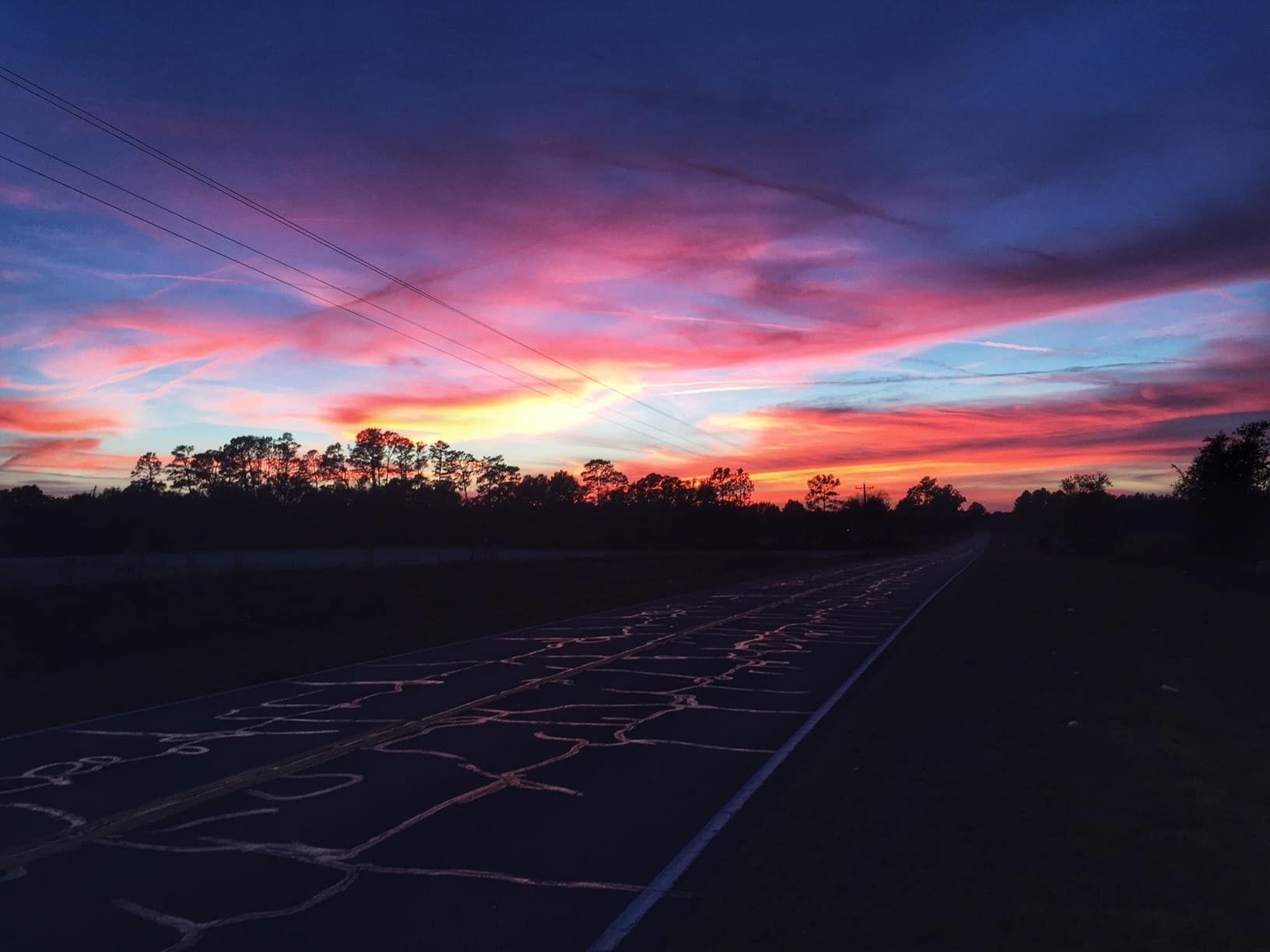 View of sunset over road towards Bell, Florida © Raymond Hines.