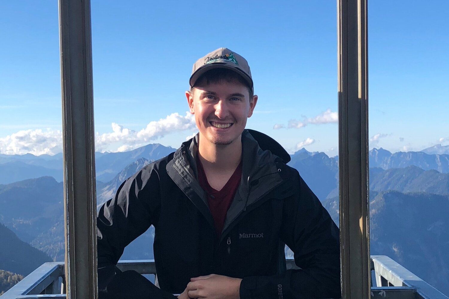 My smiling face in front of Austrian mountains.