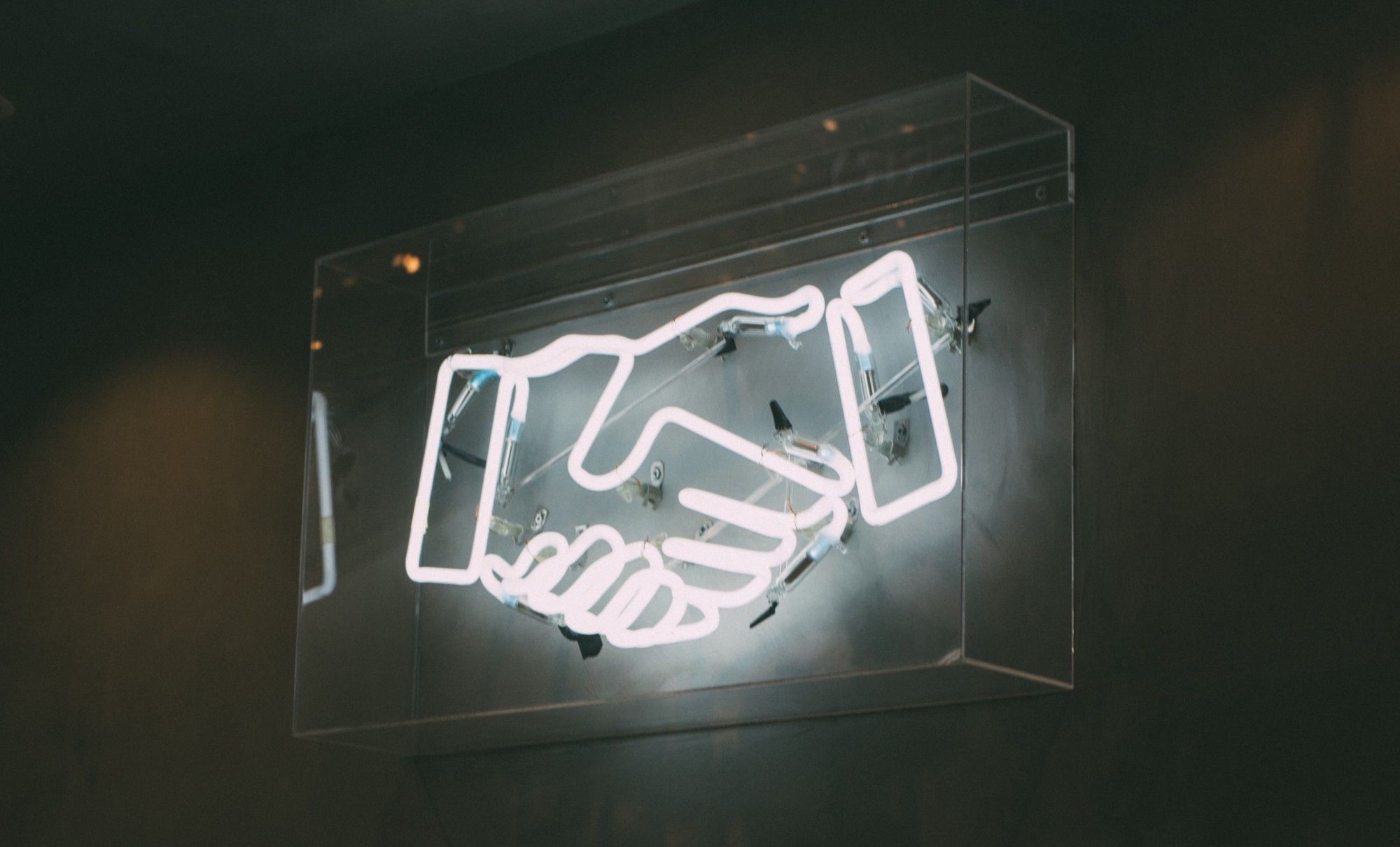 Led-lit handshake on a wall