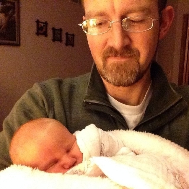 Dad holding infant.