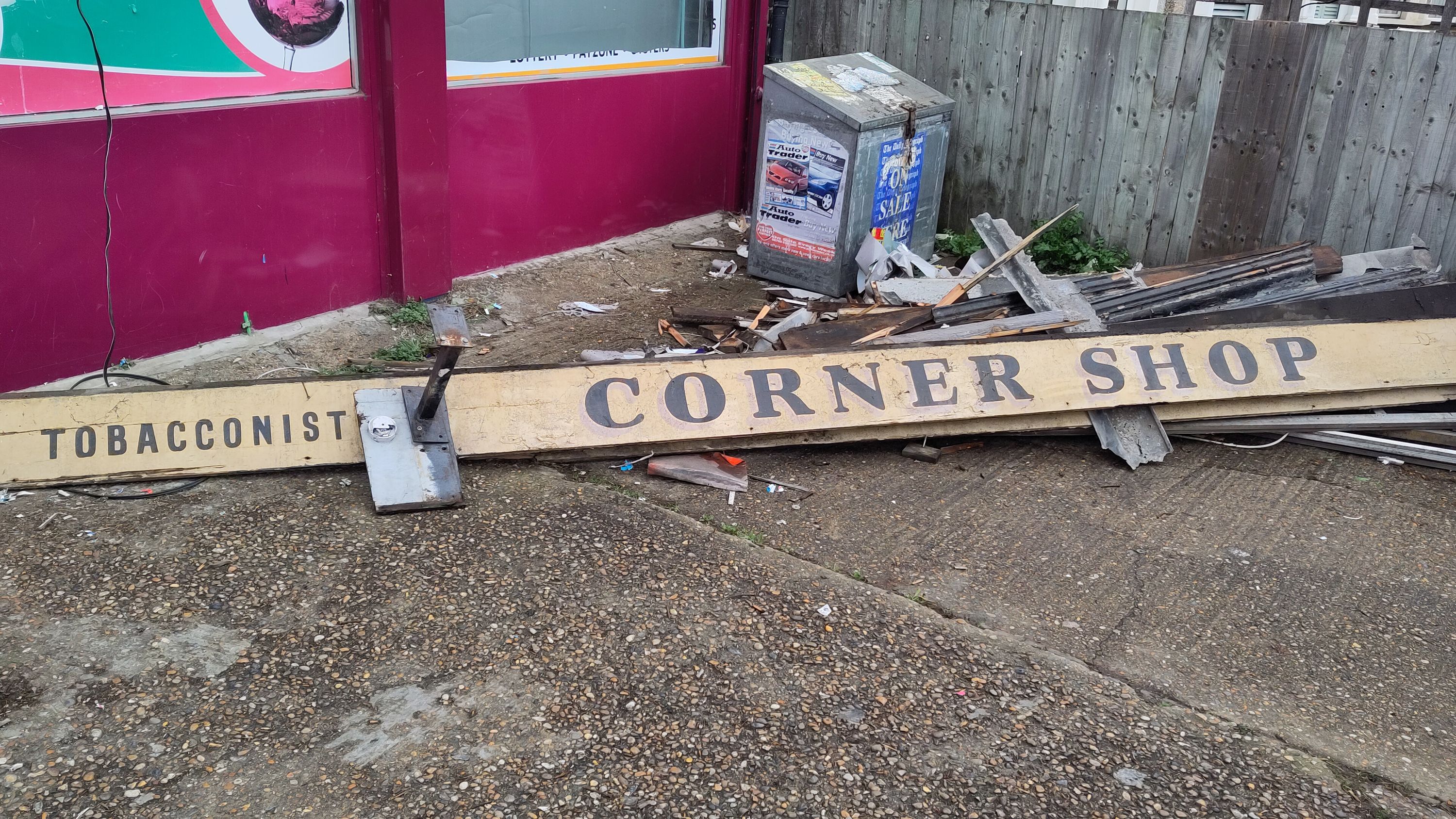 The cornershop was peeling back the layers during a renovation and torn out this cool old sign