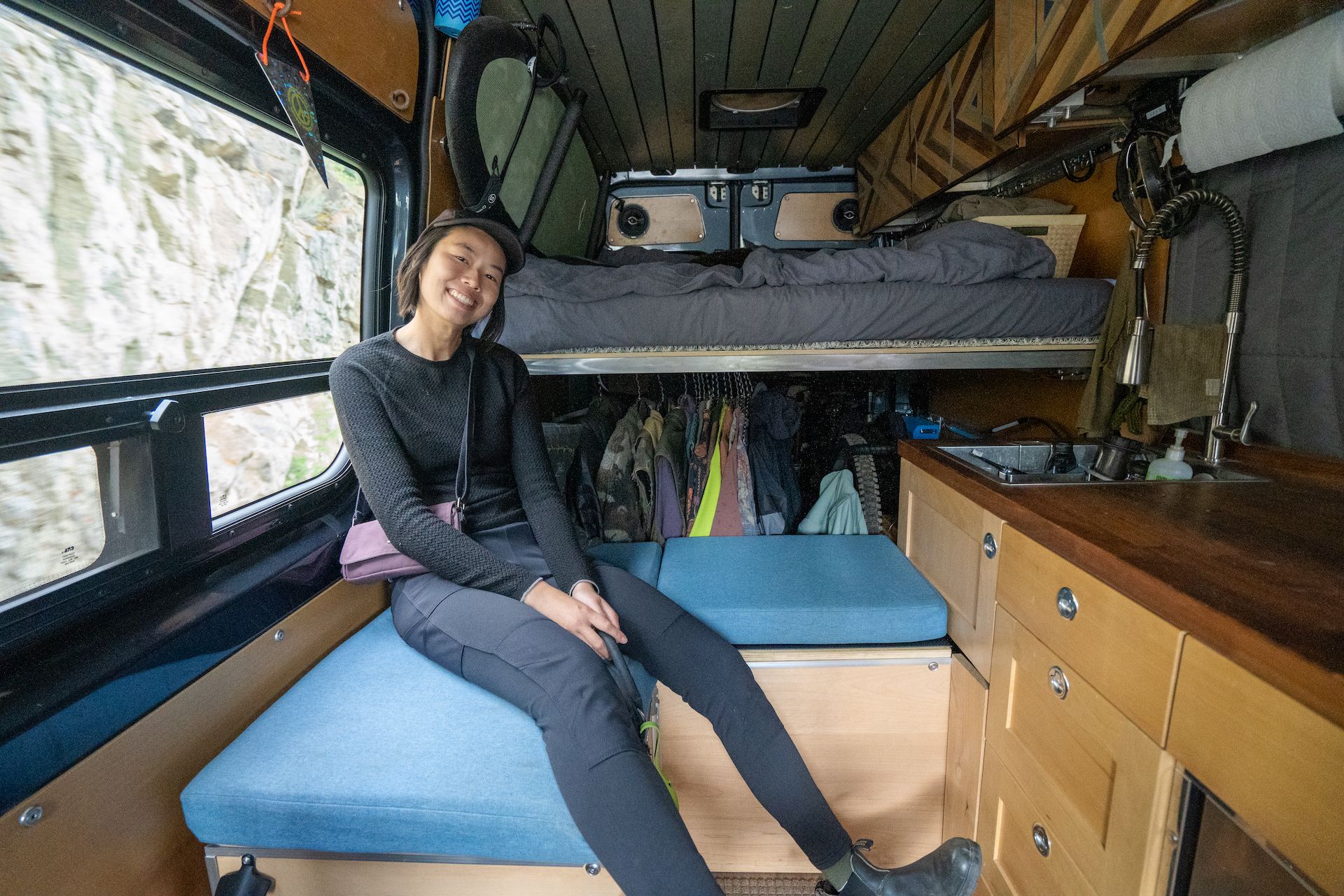 Kuan comfortable in the back. Ali built almost everything in the van himself. Look at the ceiling and cabinetry details! 🤩