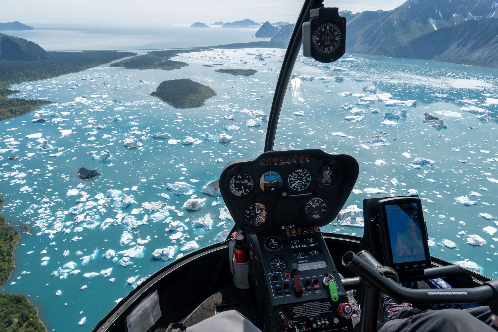 Flying over the icebergs in the Bear Glacier Lagoon. You can see the ocean in the distance.