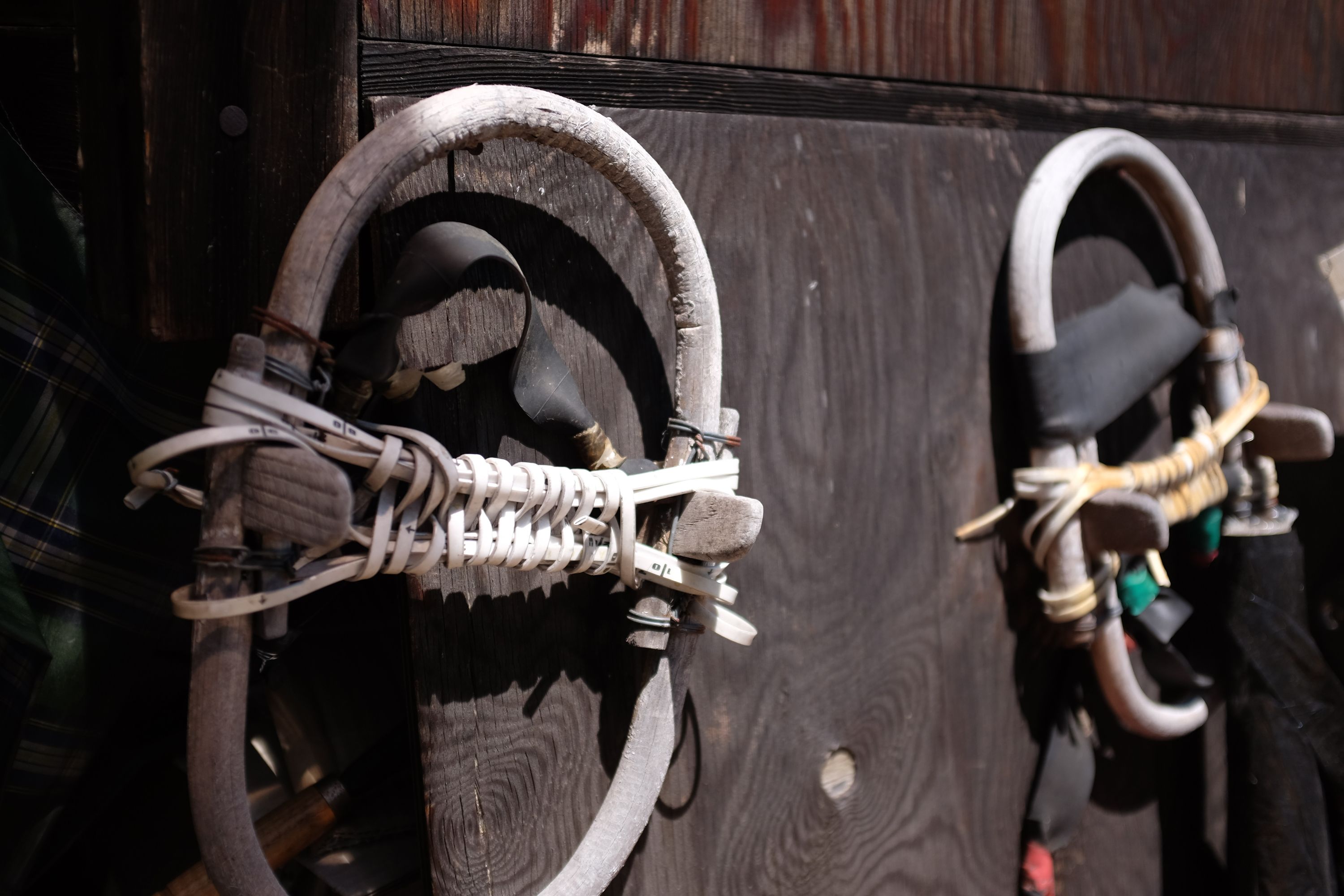 A pair of old snowshoes on a wall.