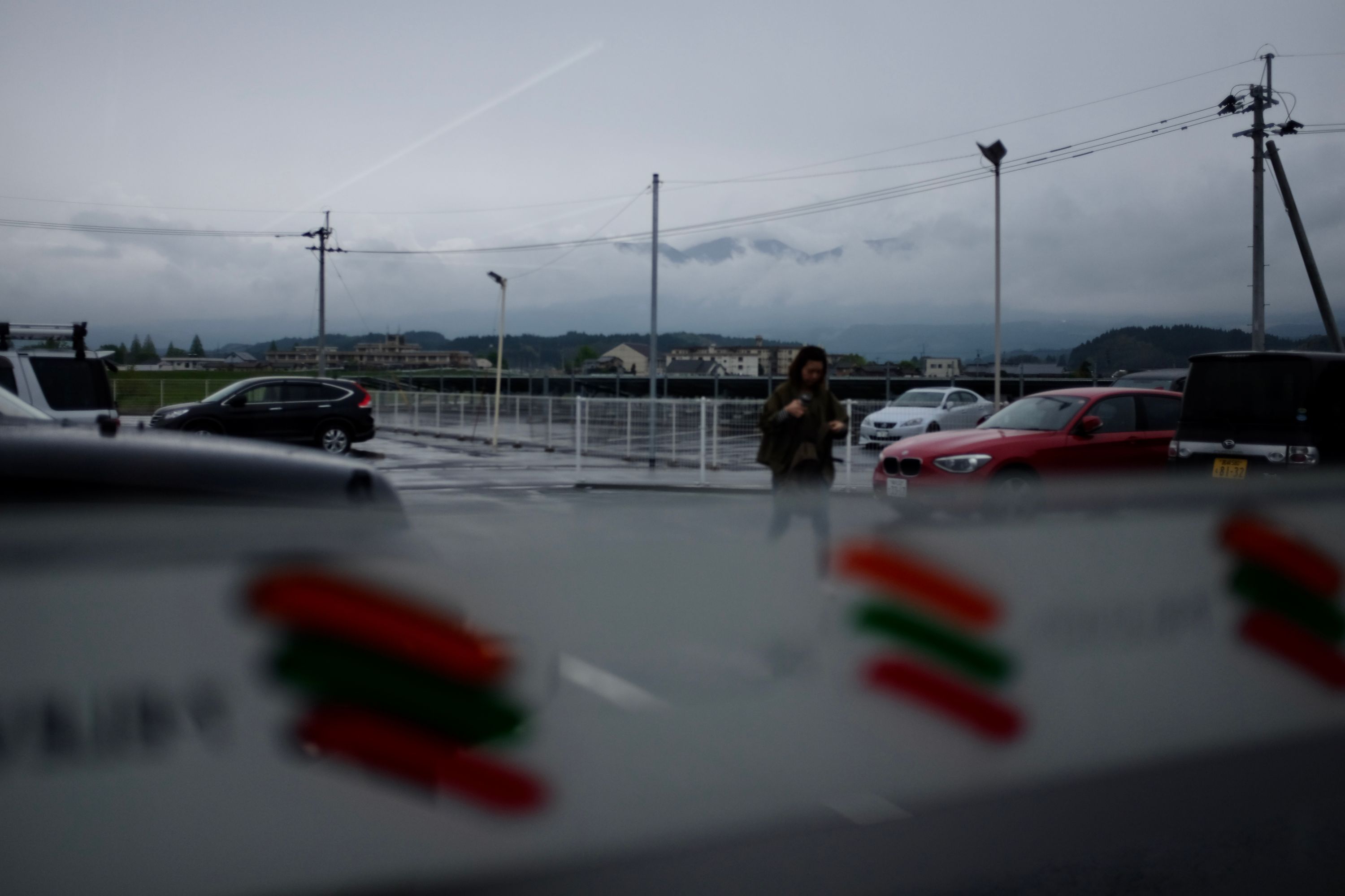 Looking out on the parking lot of a convenience store on a rainy day.