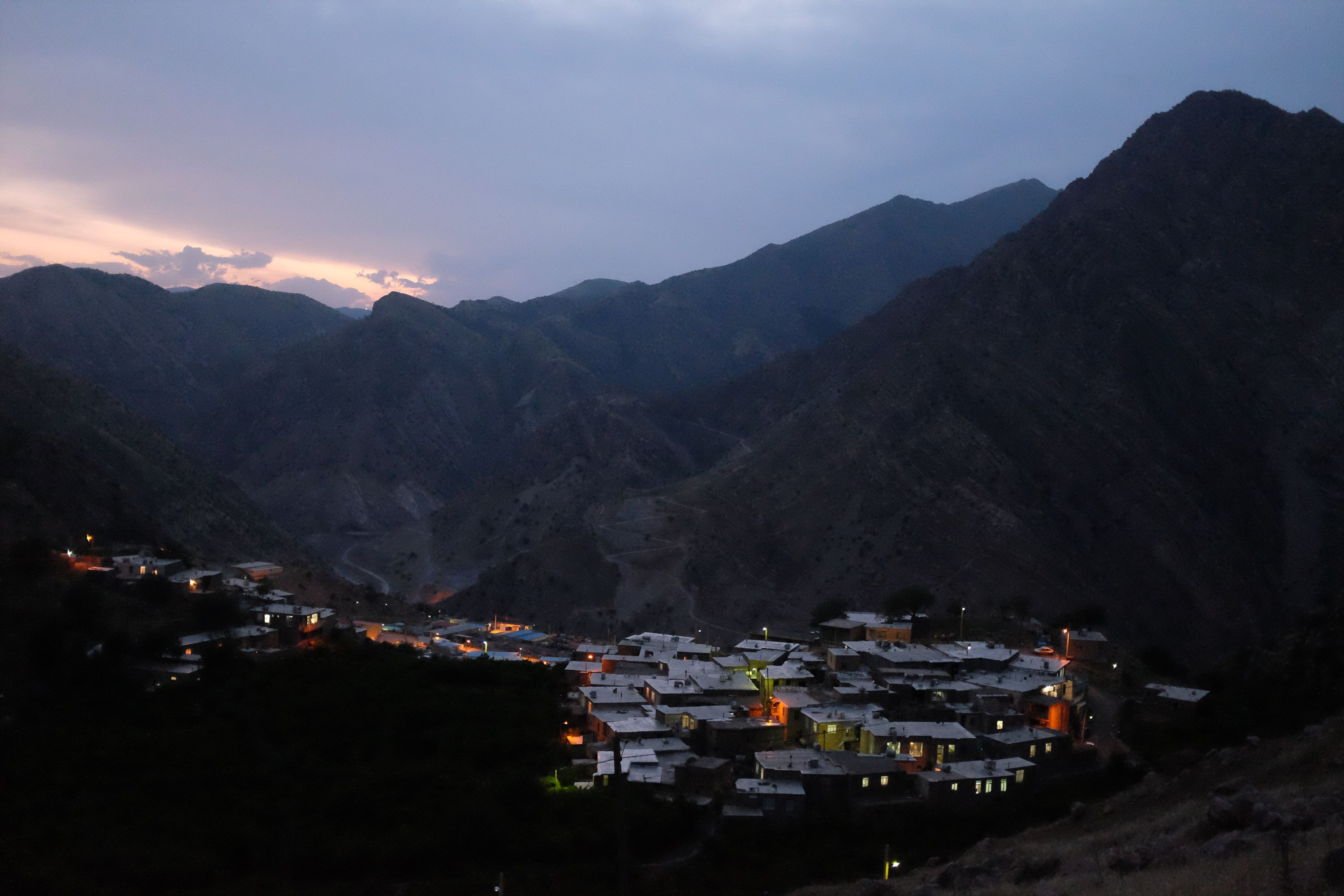 A small village in the mountains at dusk.