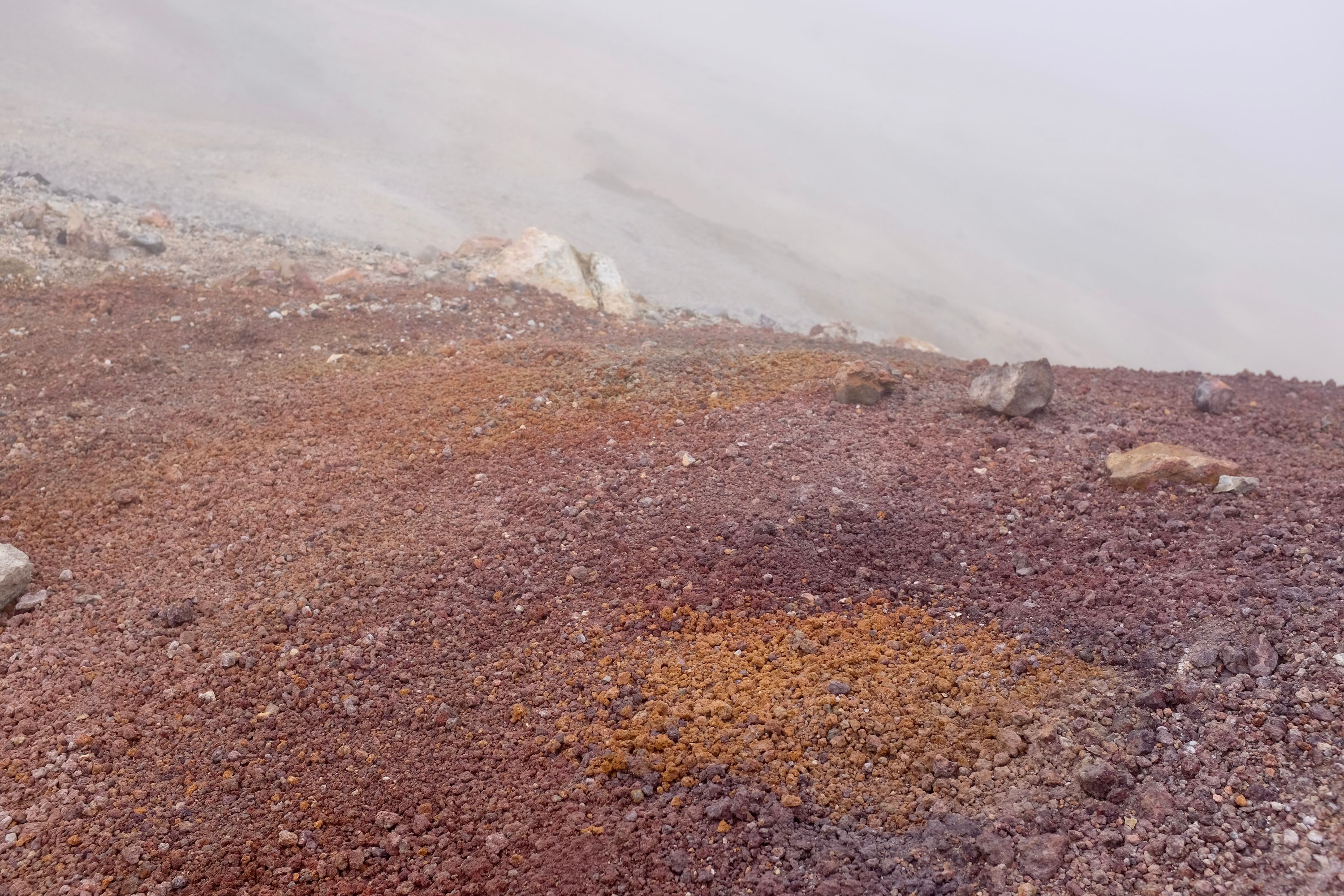 Colorful volcanic scree on the ground.