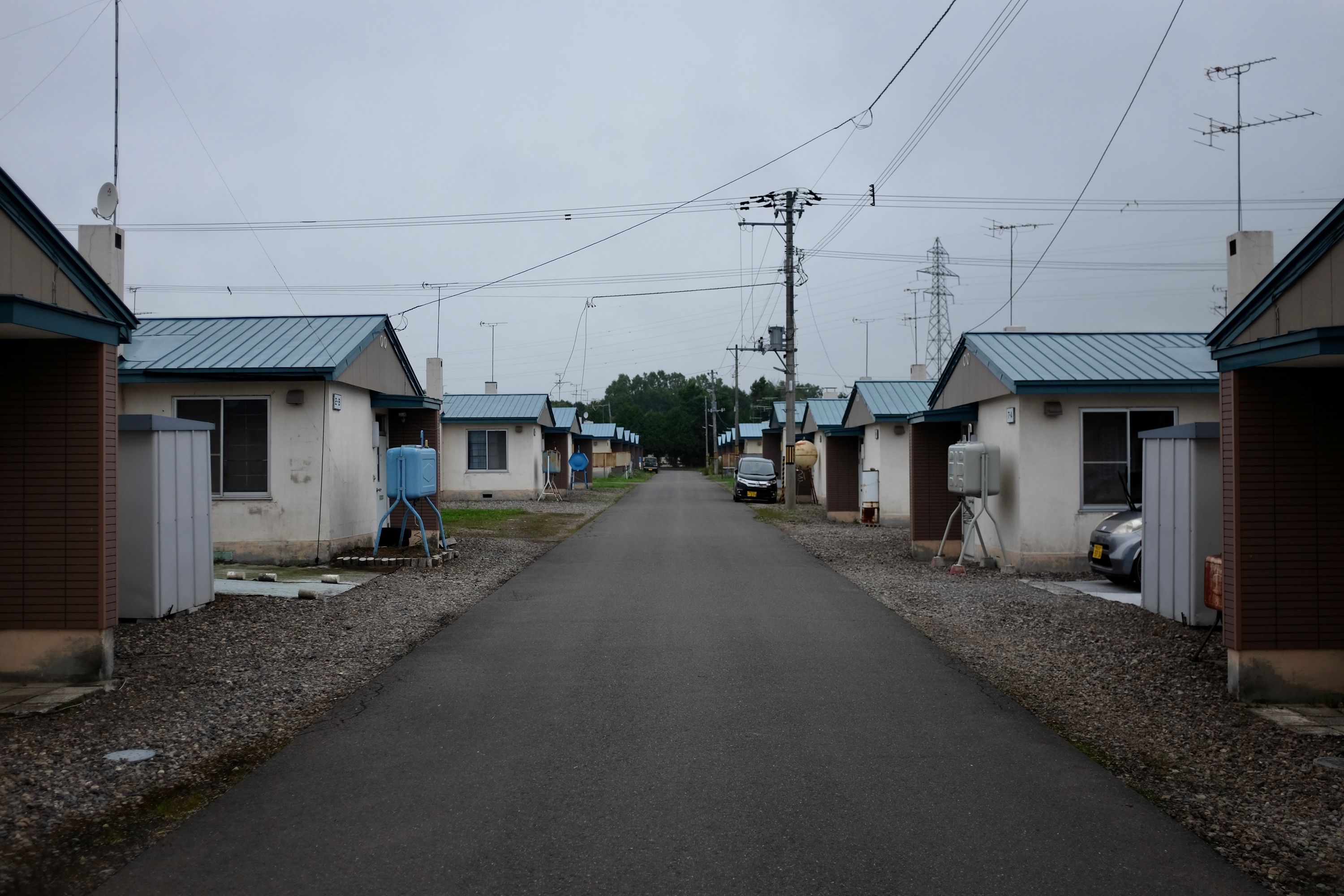 Gloomy-looking row houses on a bleak street.