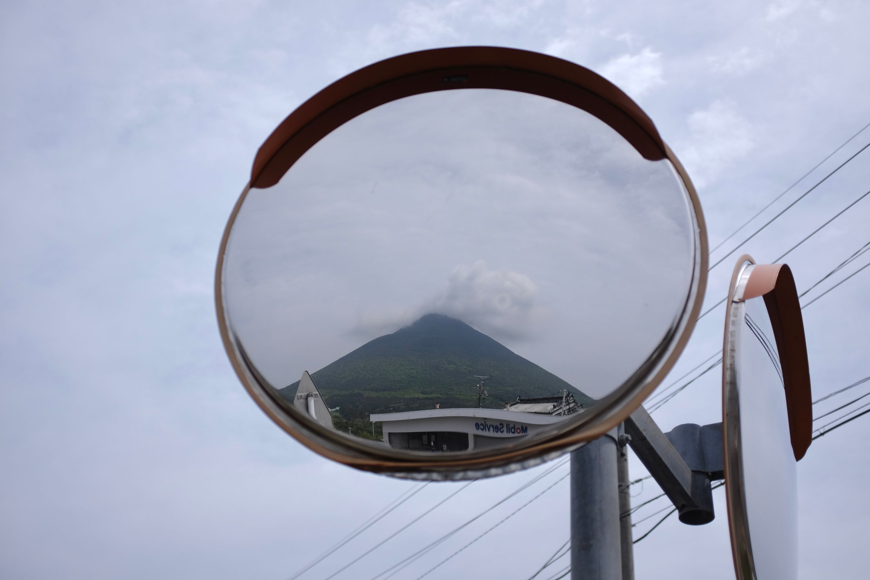 Mount Kaimon reflected in a traffic mirror.