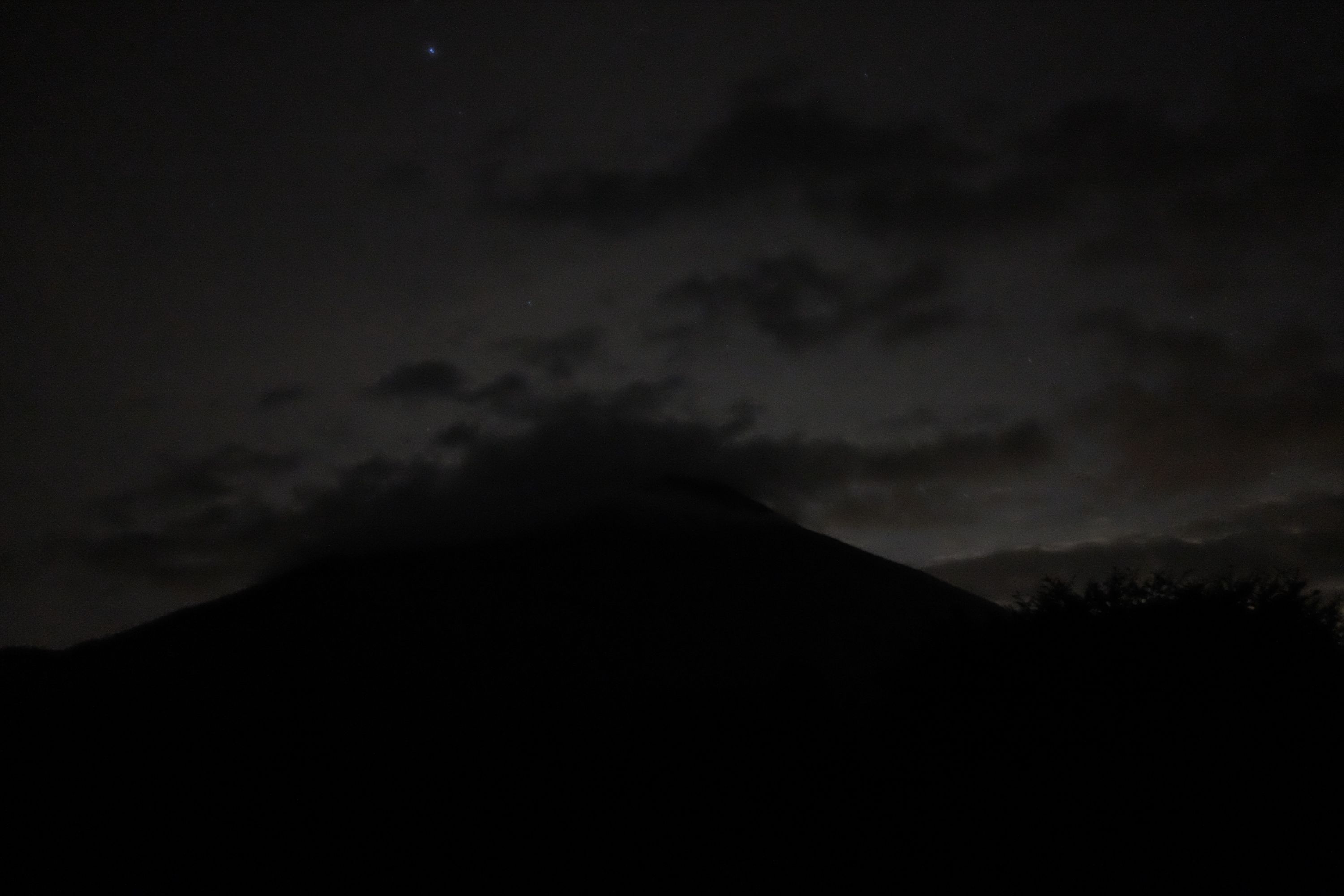 The silhouette of Mount Nantai against the evening sky.