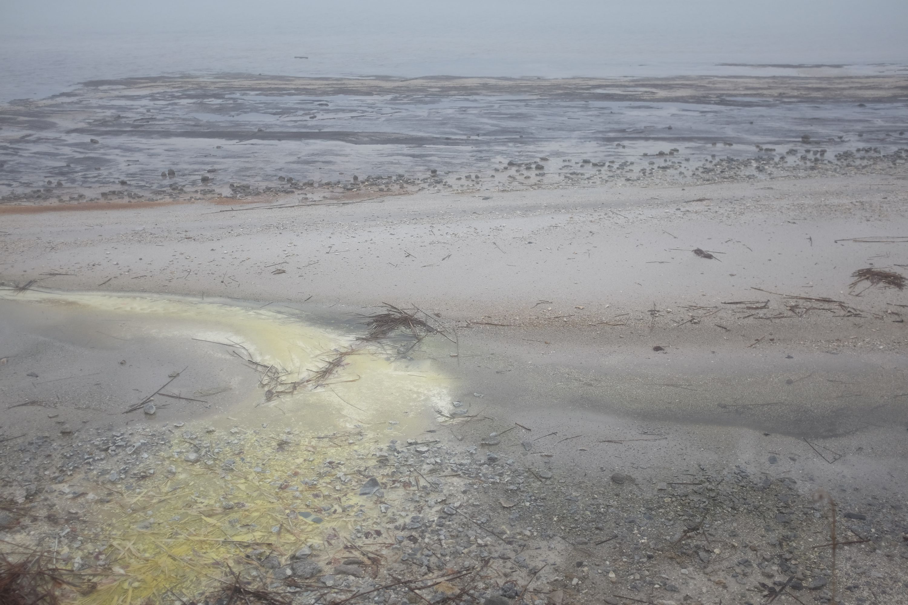 A sulphur deposit on a lakeshore.