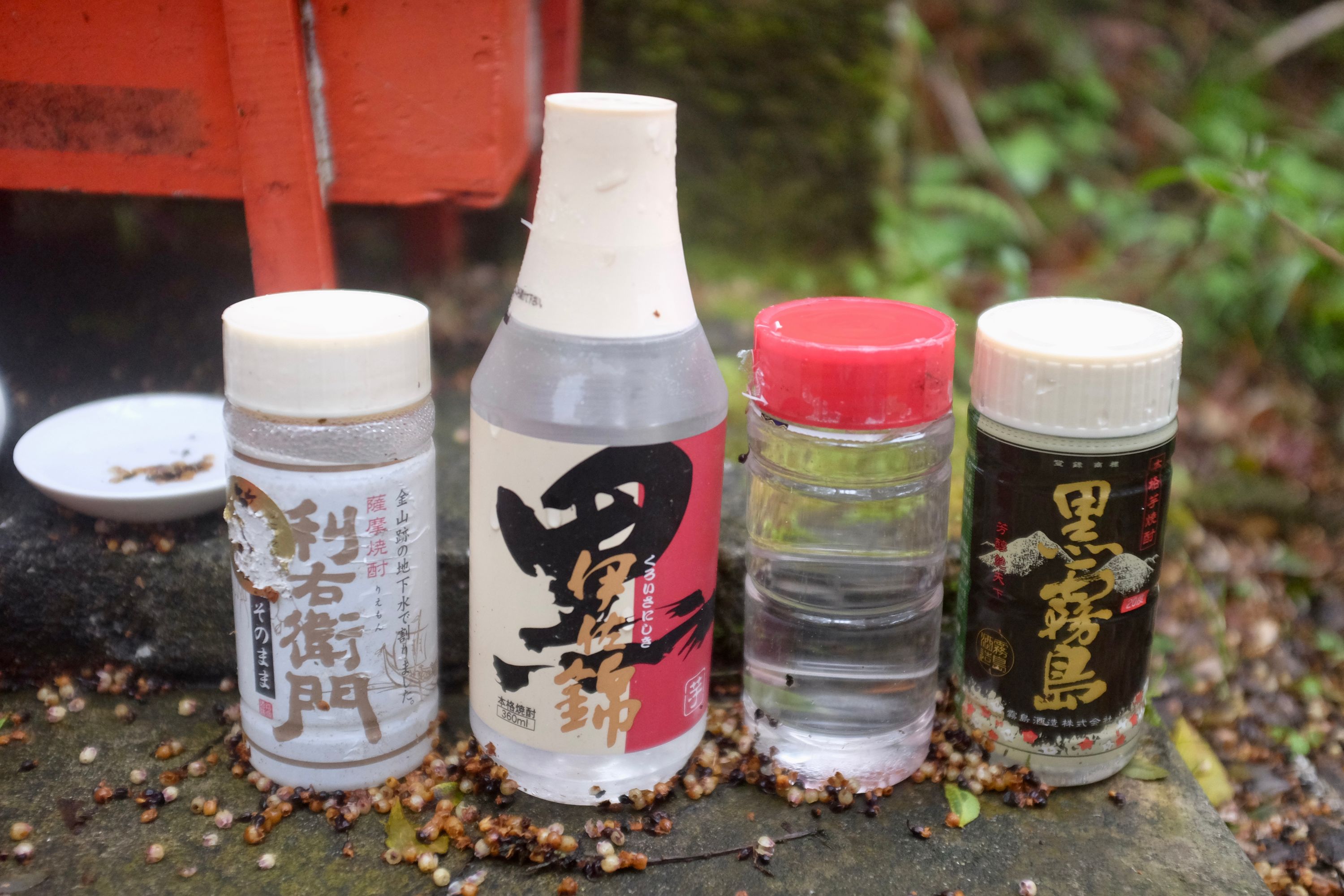 Offerings of shōchū to the volcano god at the summit shrine of Mount Kaimon.