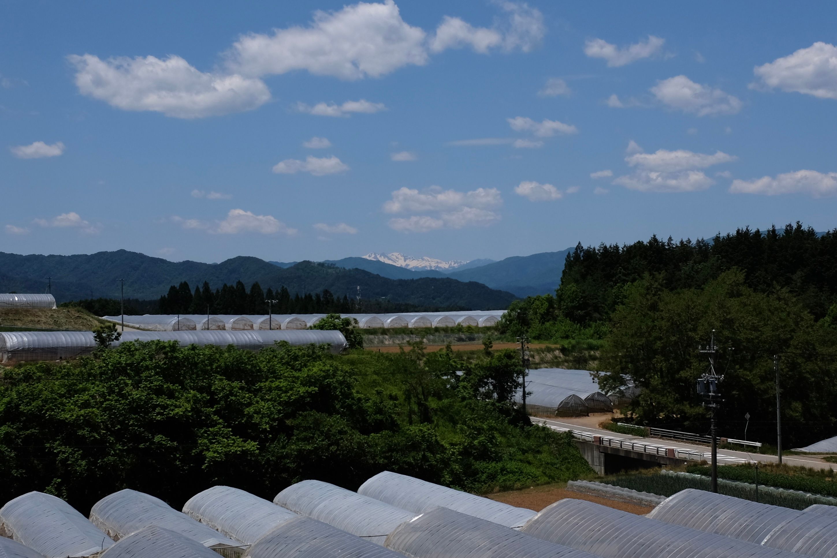 A view of distant Hakusan across the fields from Hida Takayama, Gifu.