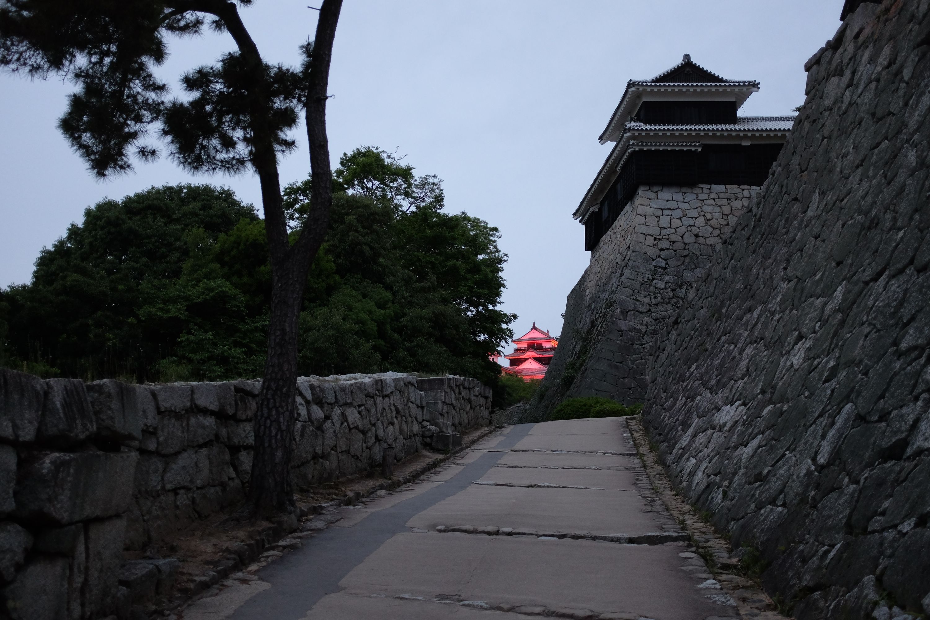 The keep of Matsuyama Castle visible at the end of one of the ramps leading into the castle.