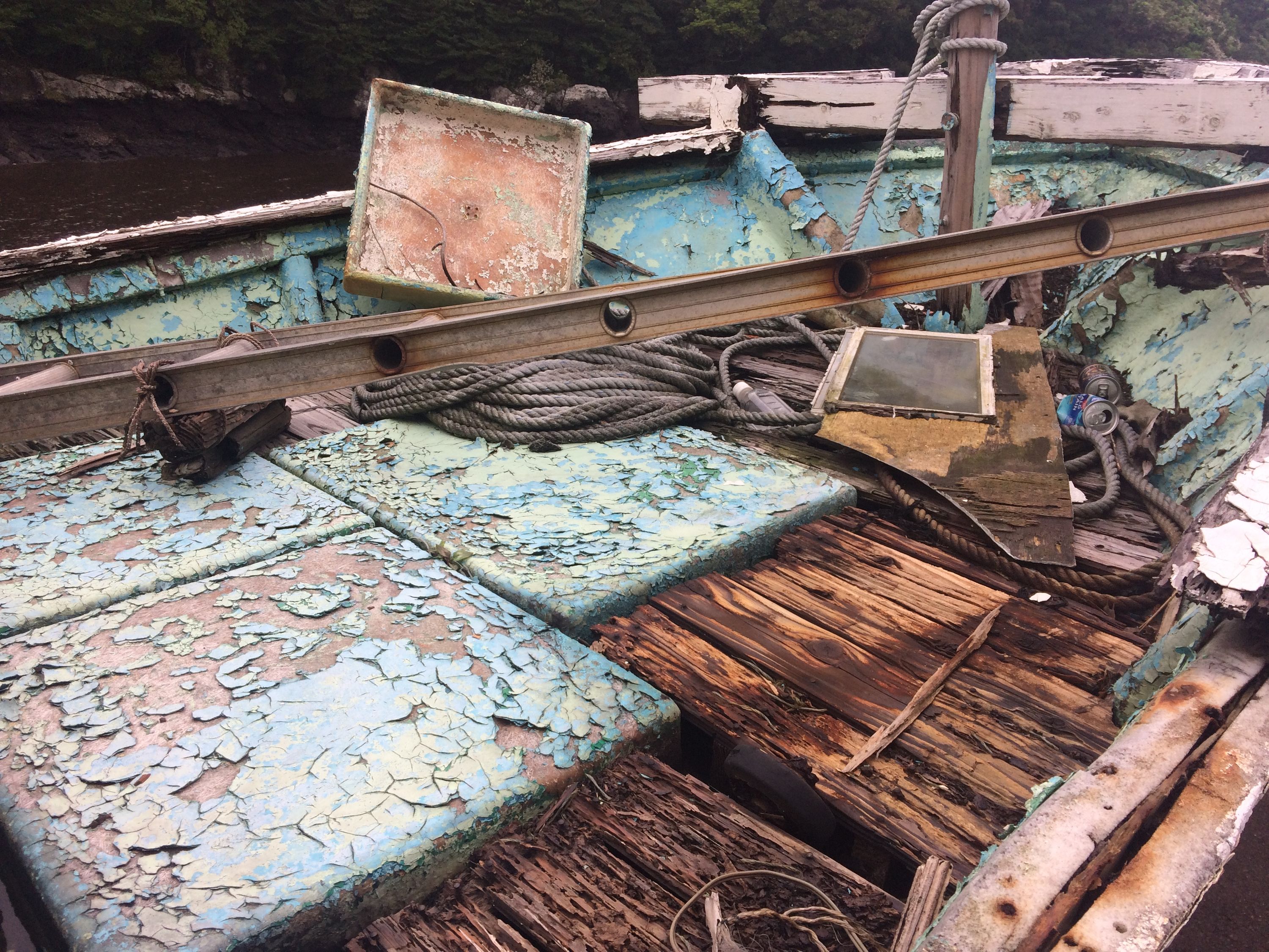 The inside of a dilapidated fishing boat.