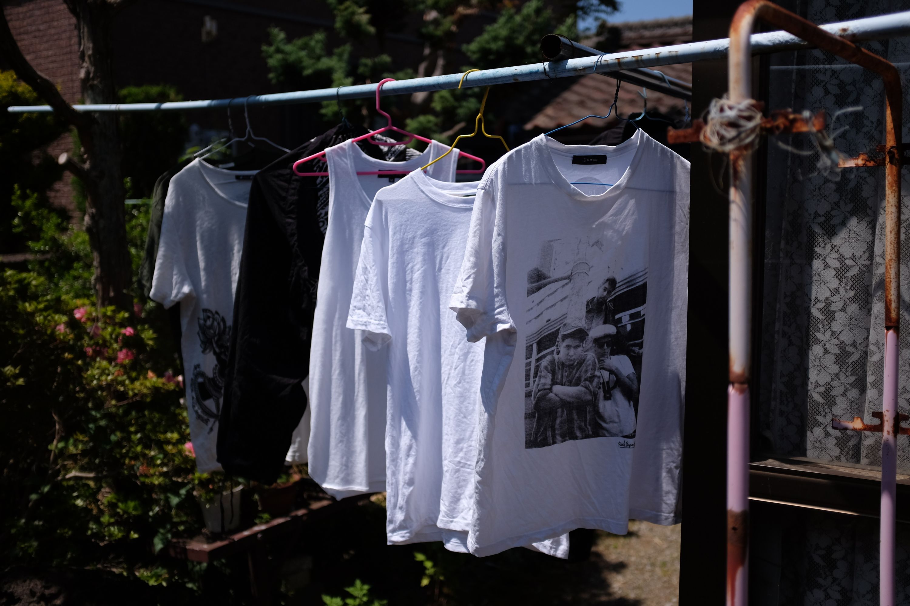 T-shirts drying on a pole.