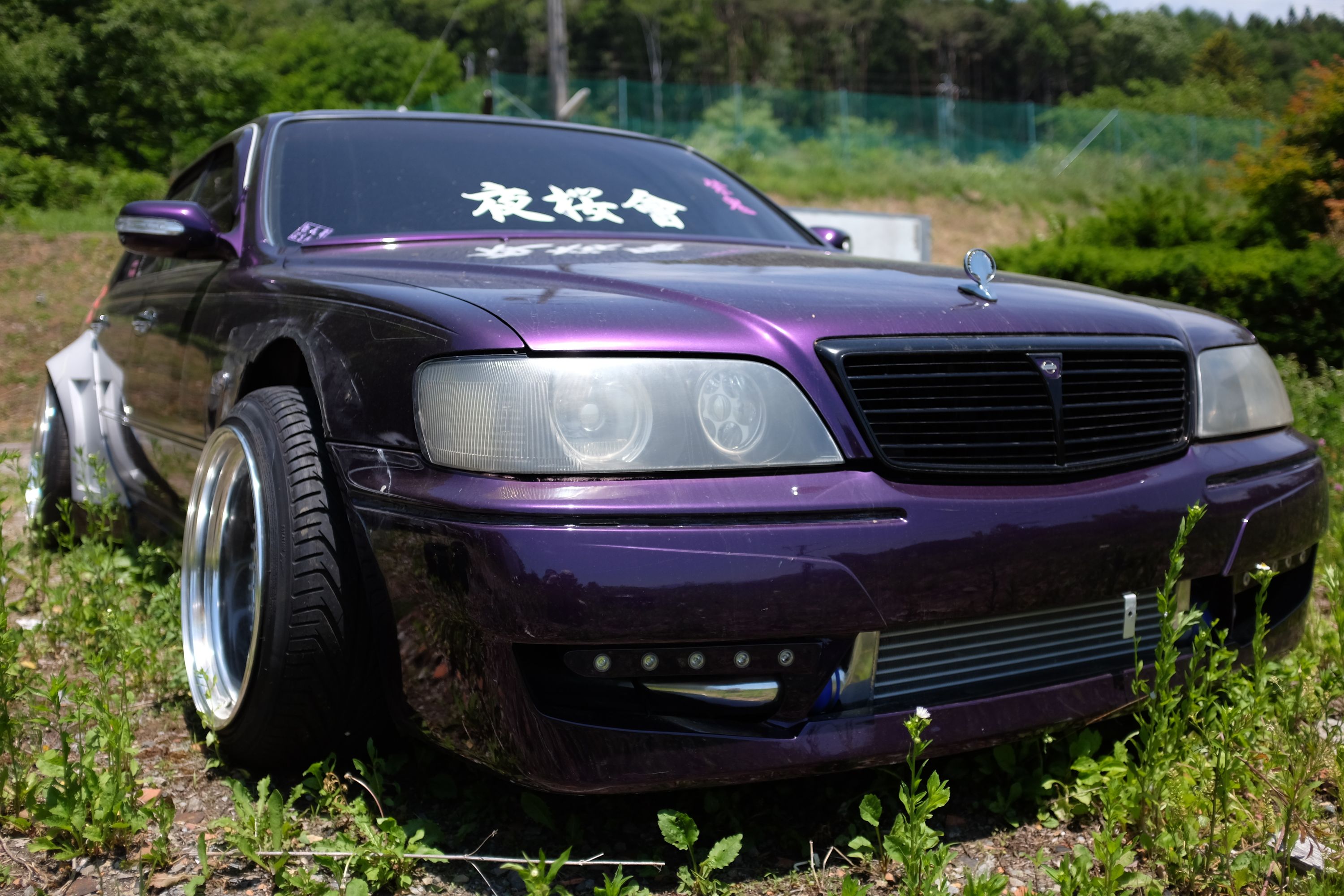A bosozuku-style purple Nissan.