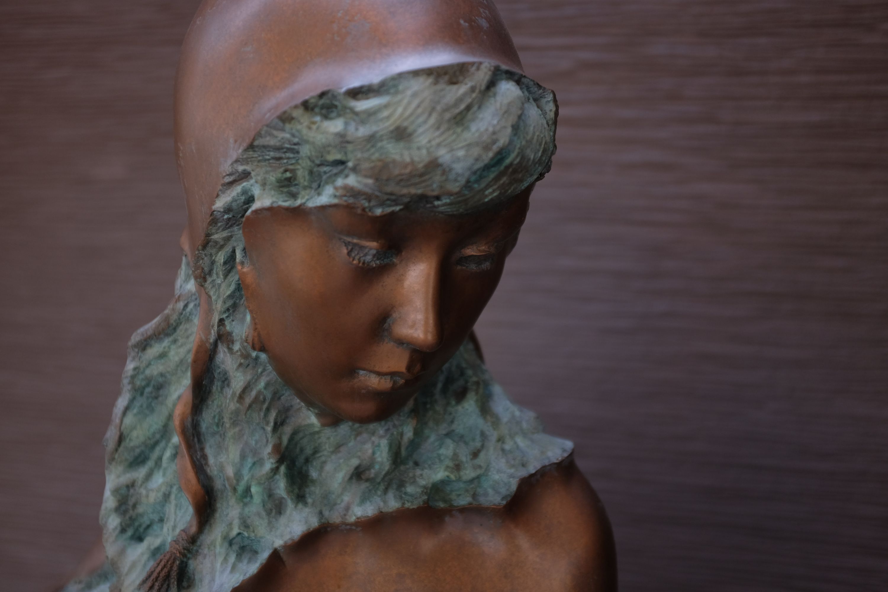 The head of a statue of what appears to be a sea fairy.