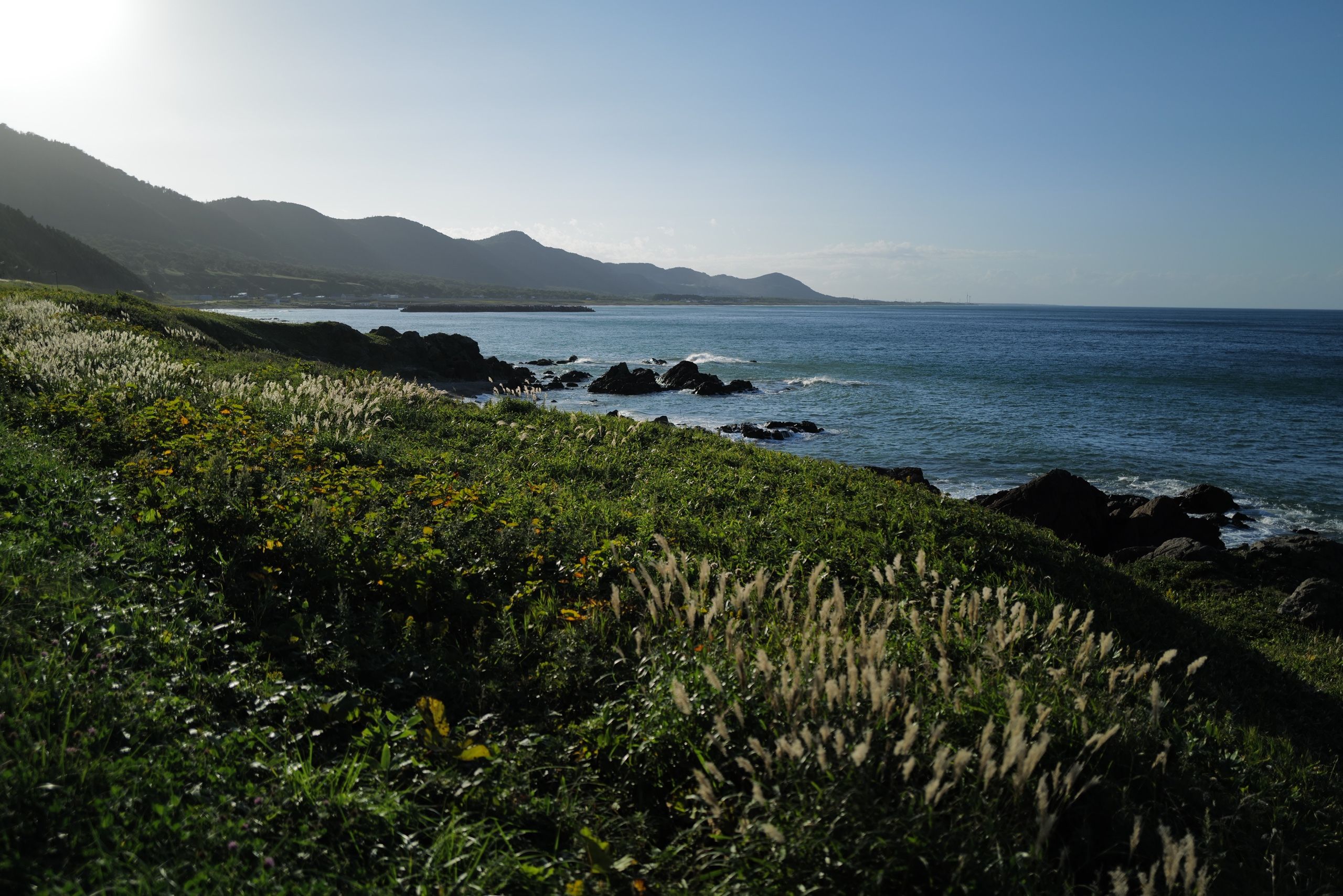 A rugged, hilly beach in the afternoon light