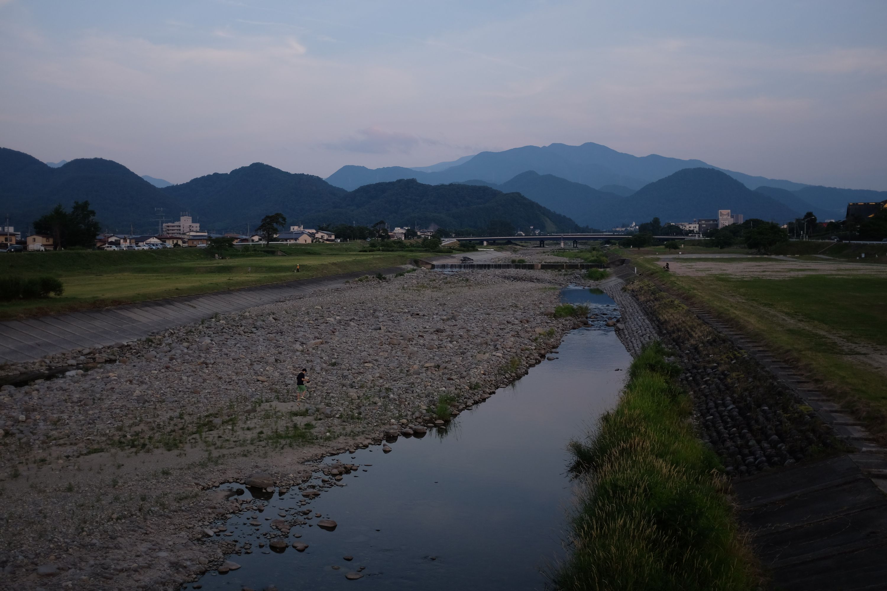 Mount Zaō in the evening light, as seen from a bridge across a stream in Yamagata City.