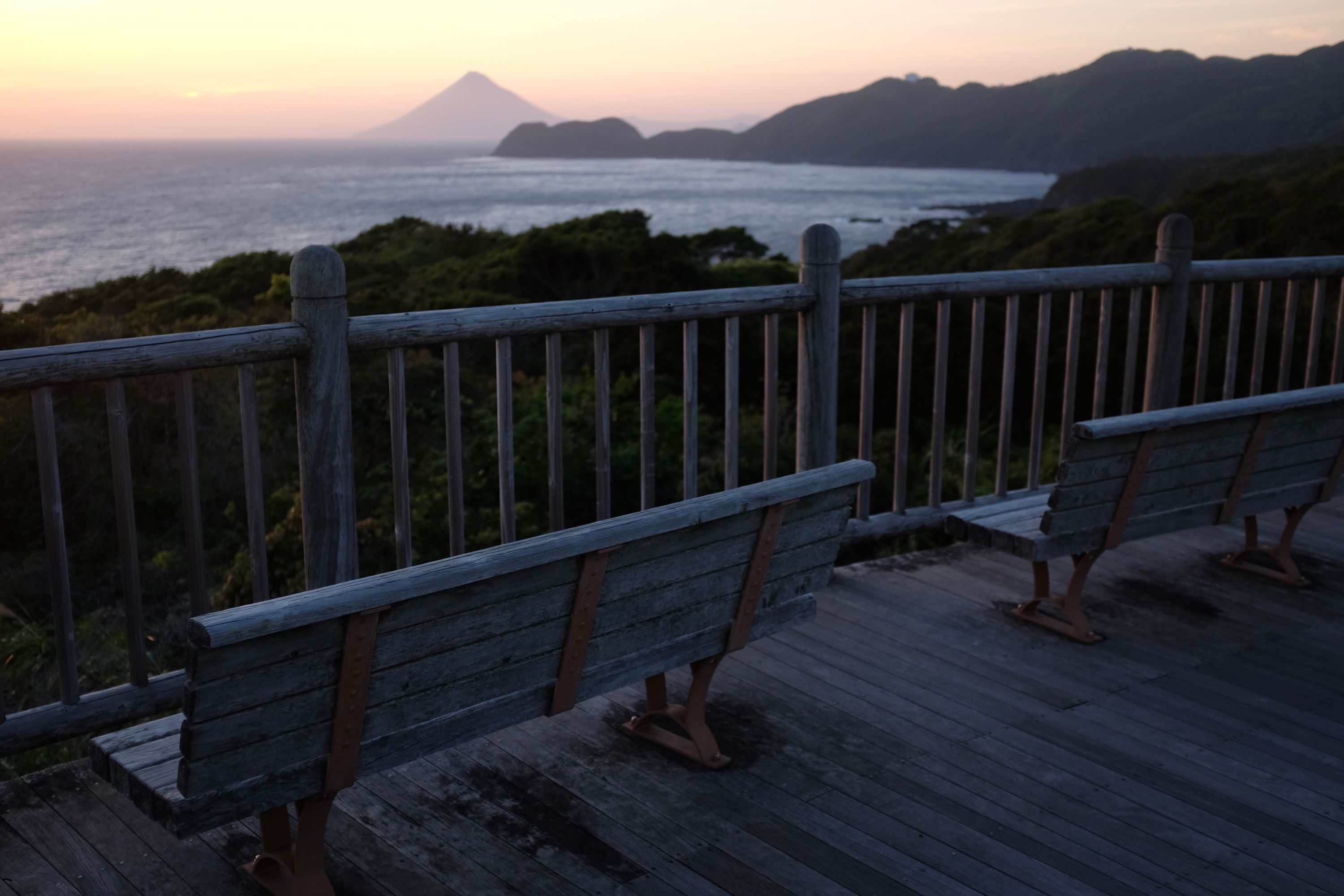 A rest stop with two benches looking out on the bay and Mount Kaimon.
