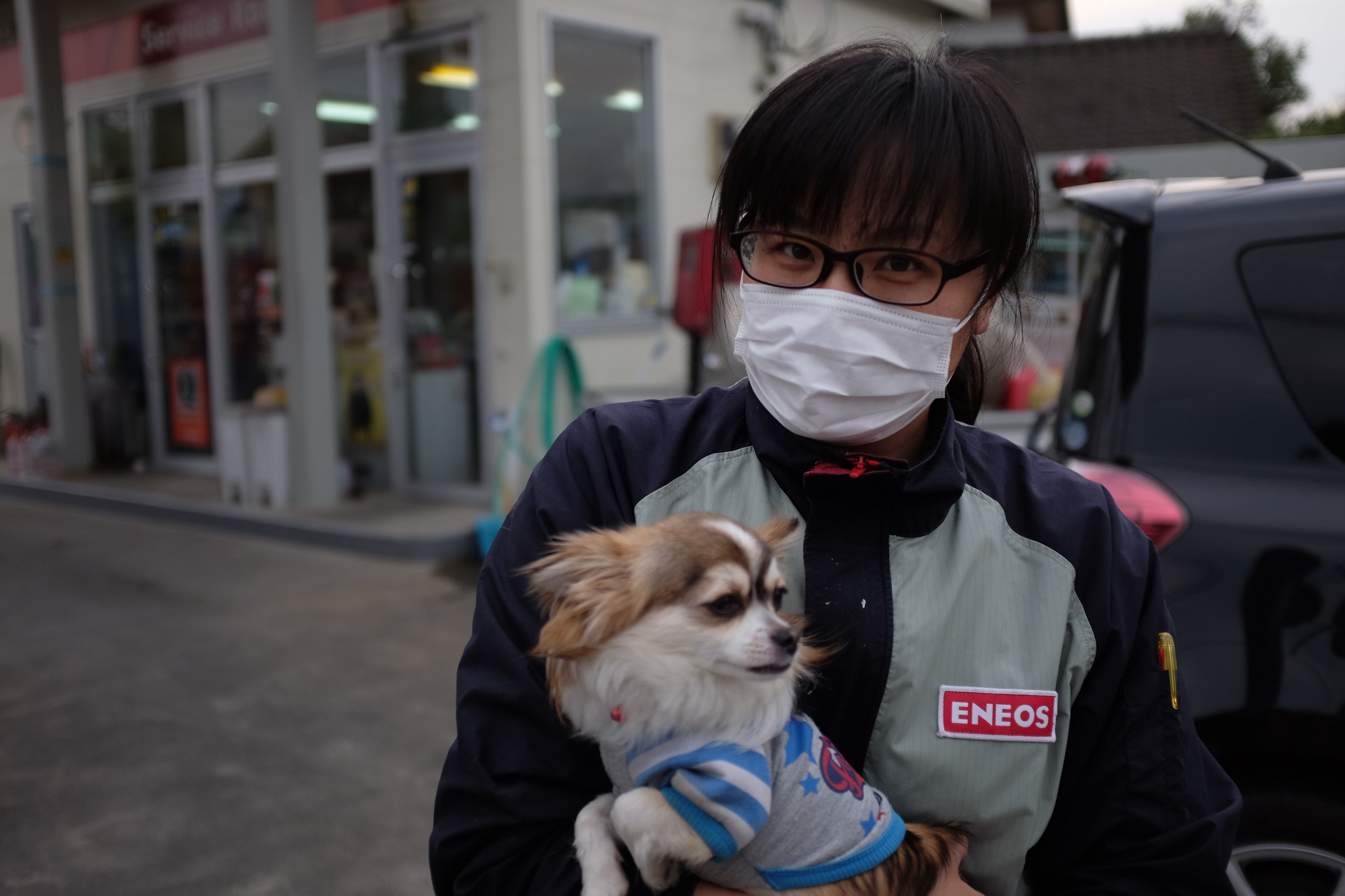 Gas station attendant with her dog in Asagiri, Kumamoto. Photo: Peter Orosz