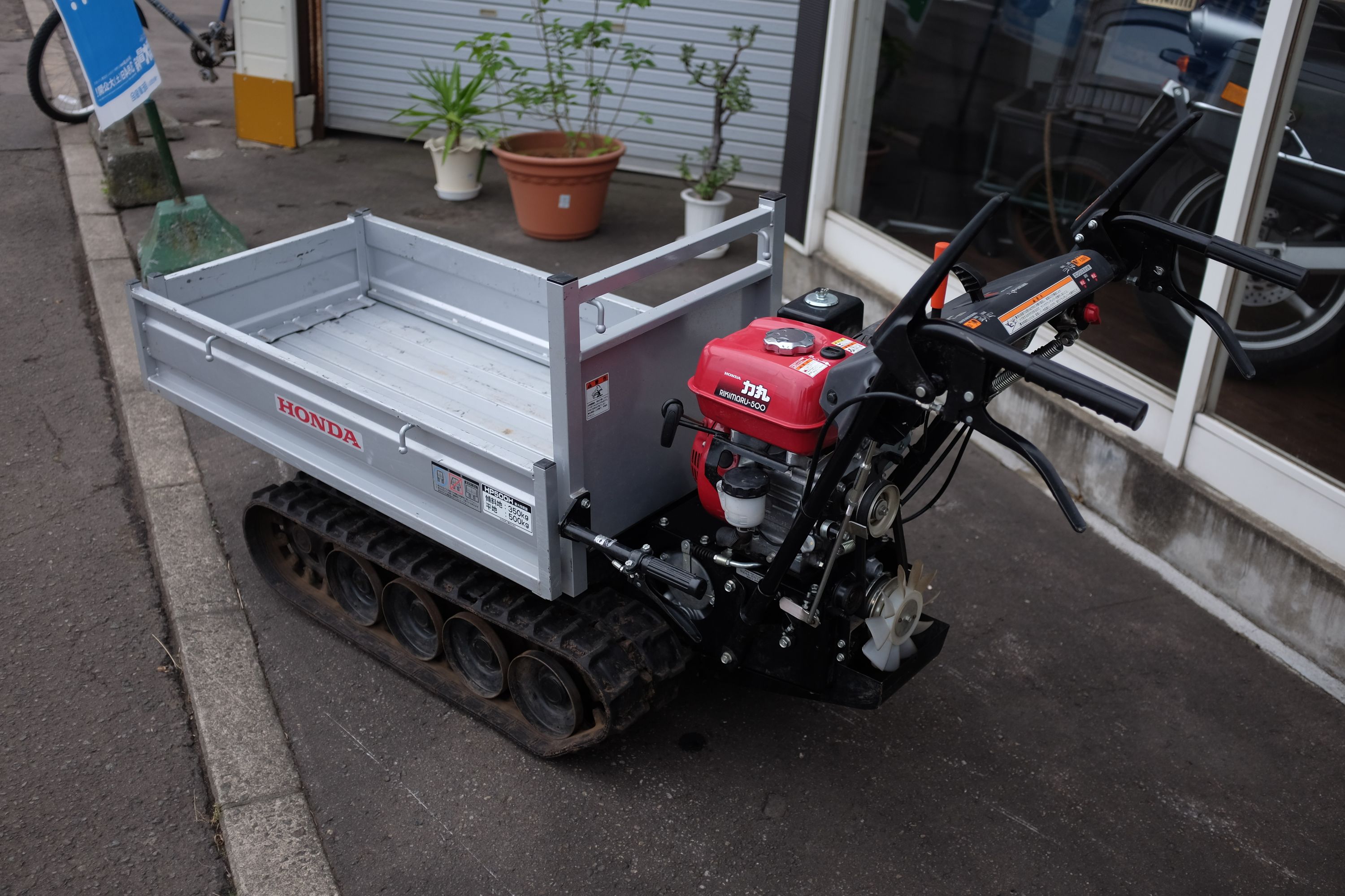 A tiny, tracked Honda transporter with a lawnmower engine.