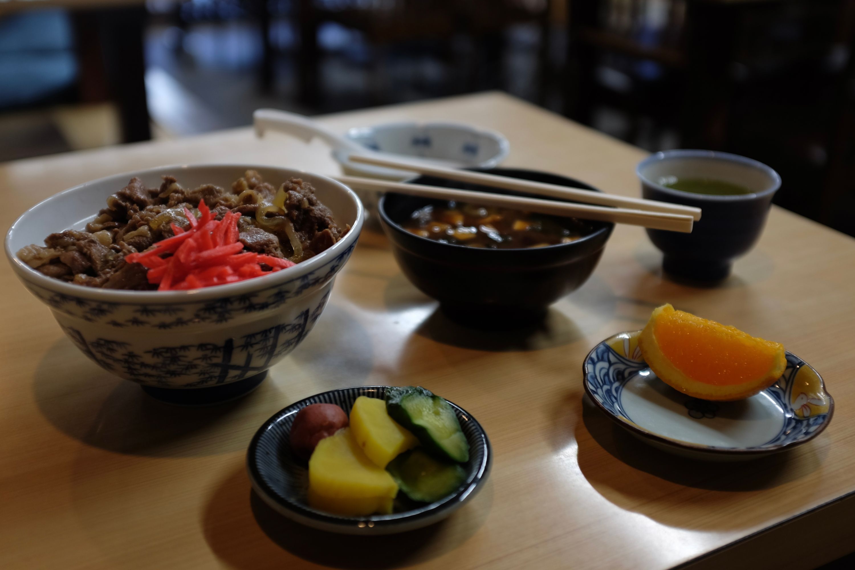 A Japanese breakfast spread on a table in a restaurant.