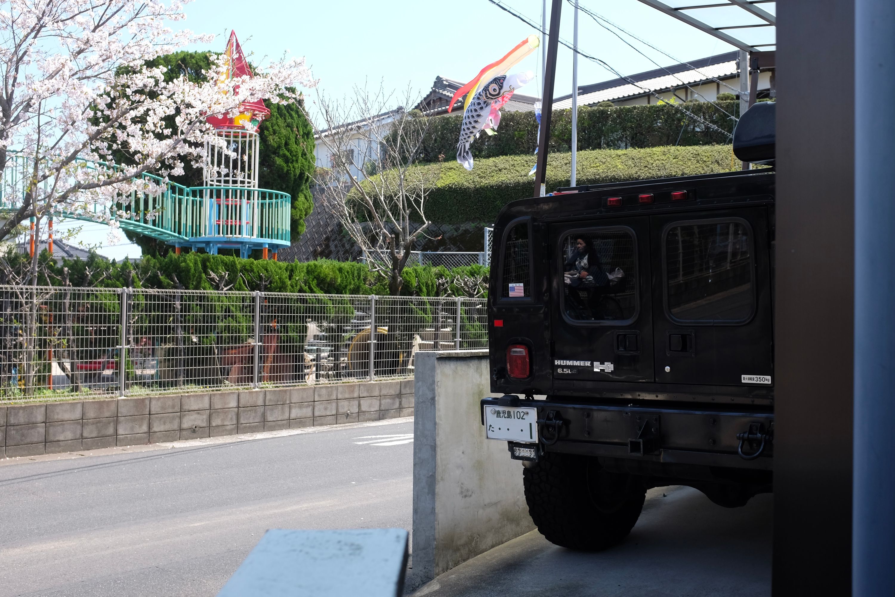 A Hummer H1 parked in a tight spot.