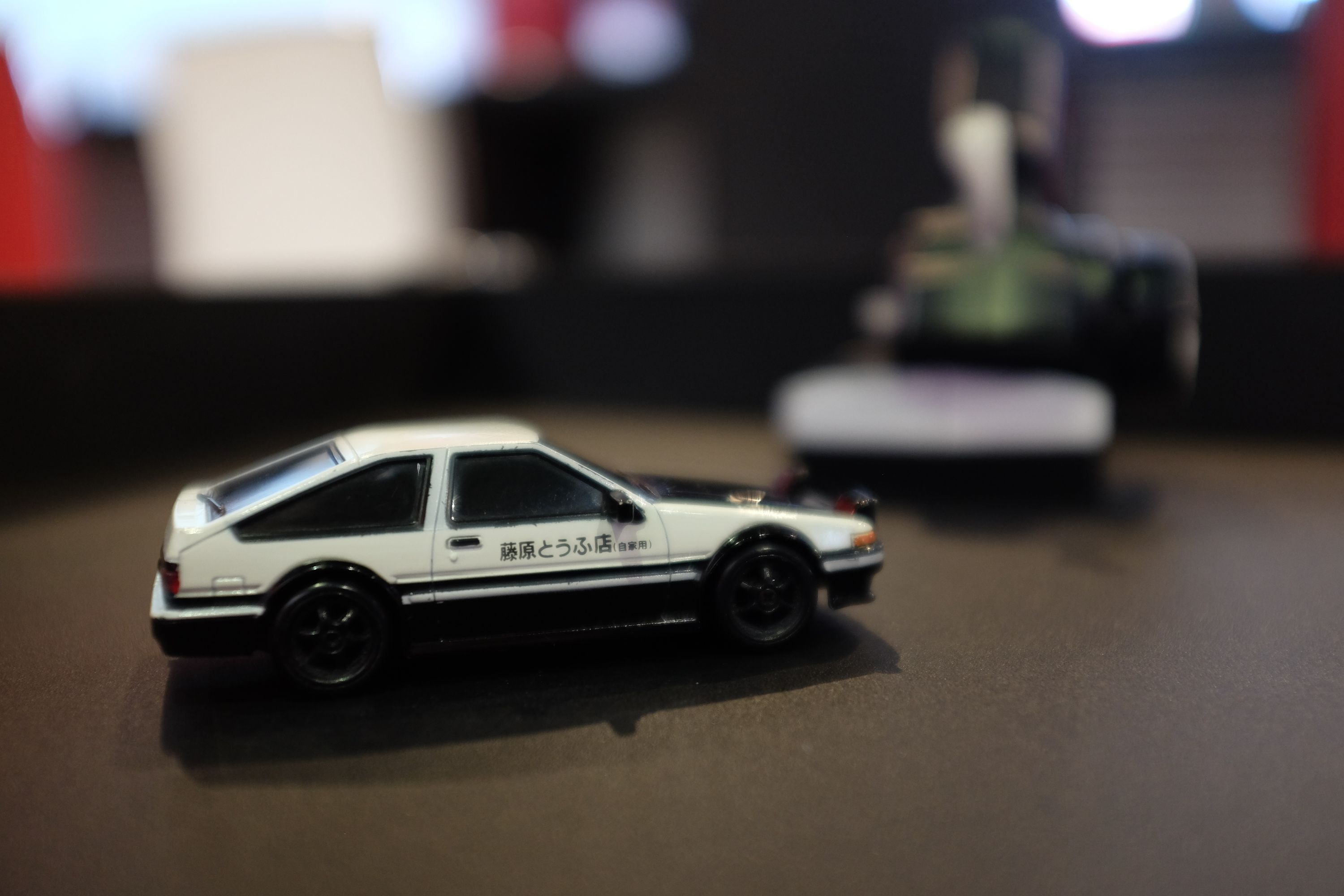 The model of a white Toyota AE86 on a table.