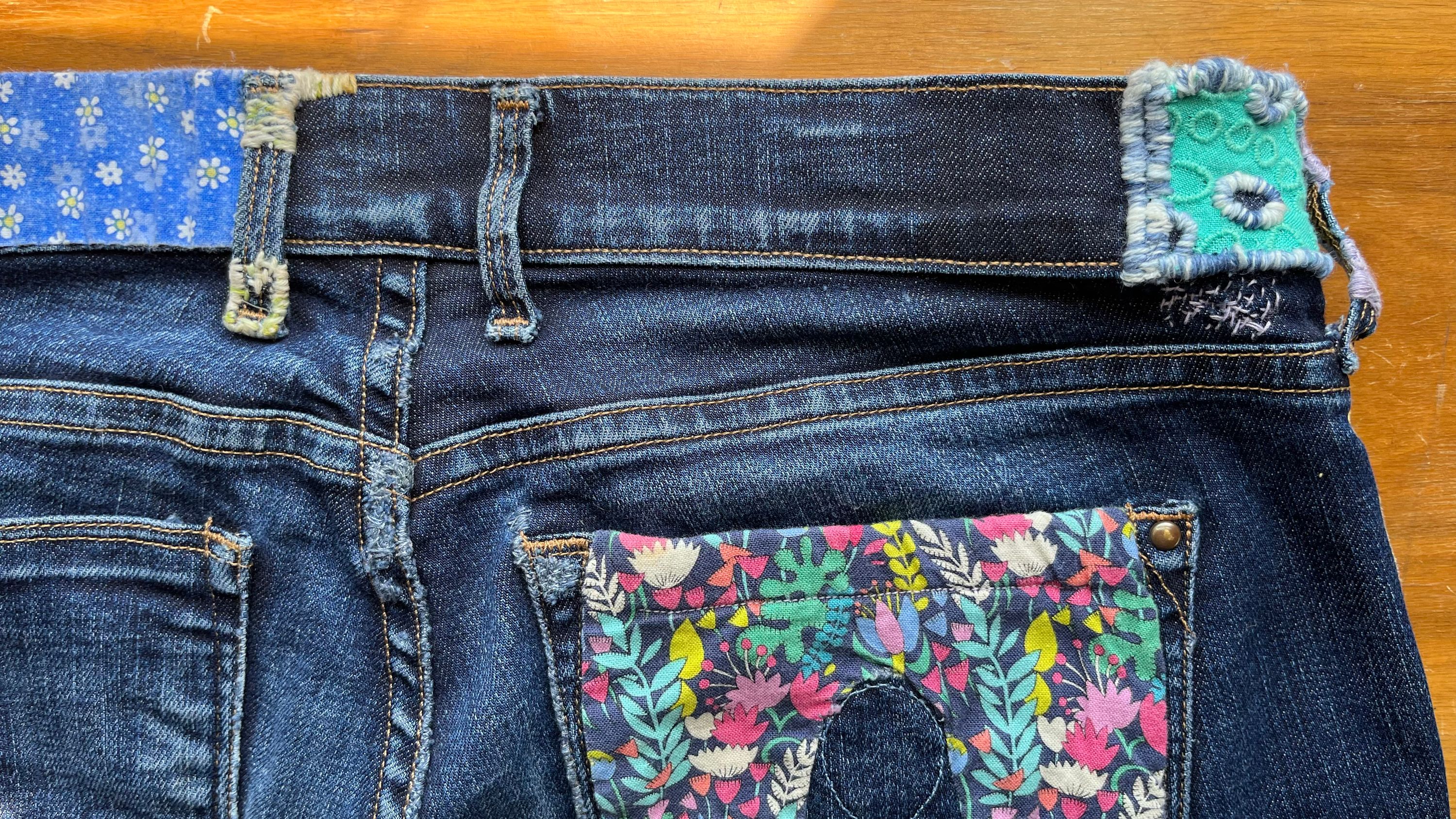 The waistband on the Work Jeans, mended with some stitches and colors.
